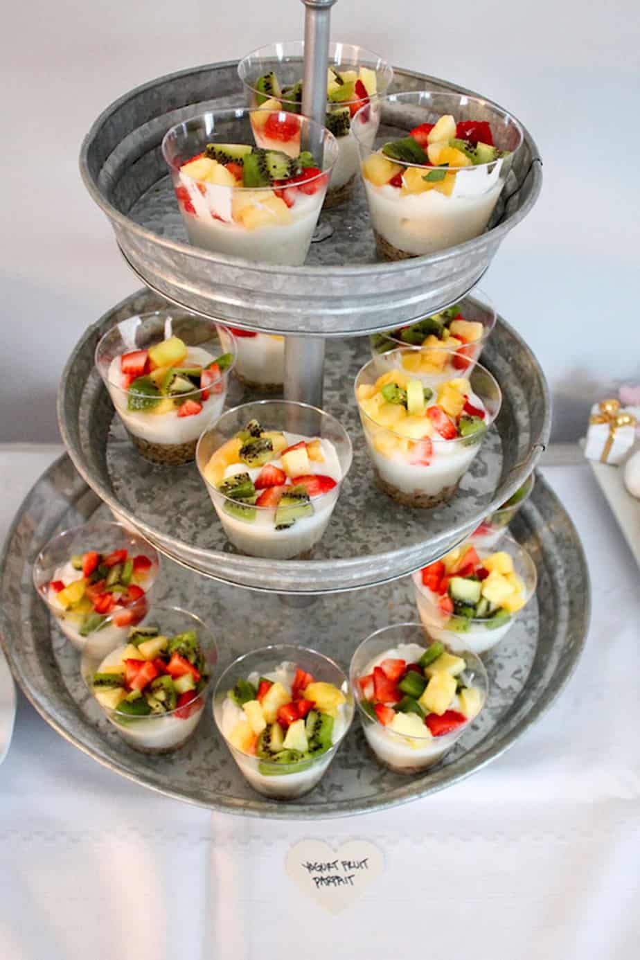 mini fruit parfaits for a baby shower set up on tiered tray