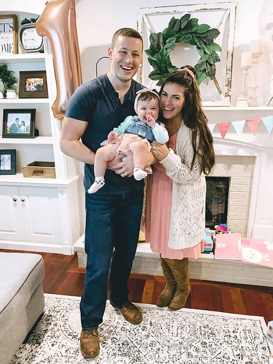 mom and dad with one year old girl at First Rodeo birthday party