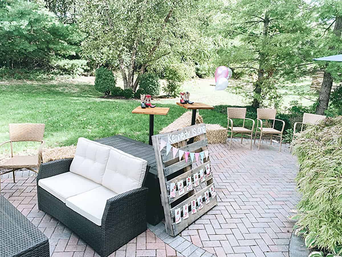 back patio with chairs and tables set up for birthday party gathering