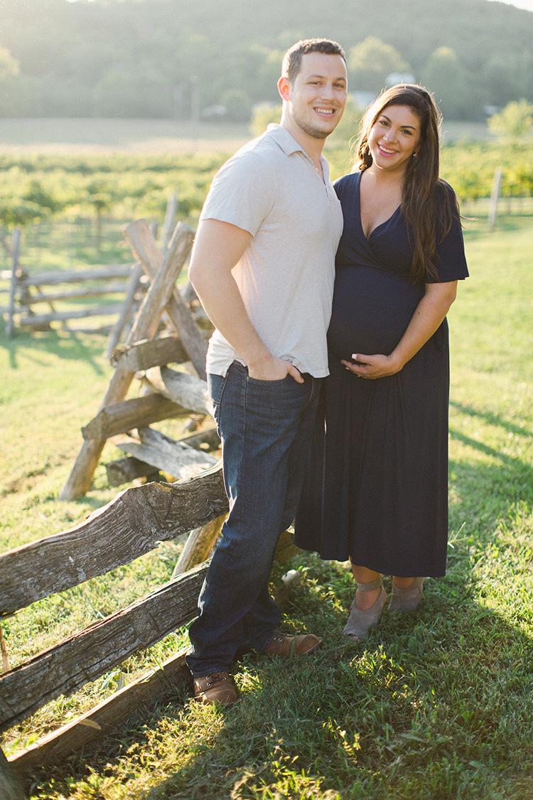 husband and wife posing for maternity photos before baby's arrival