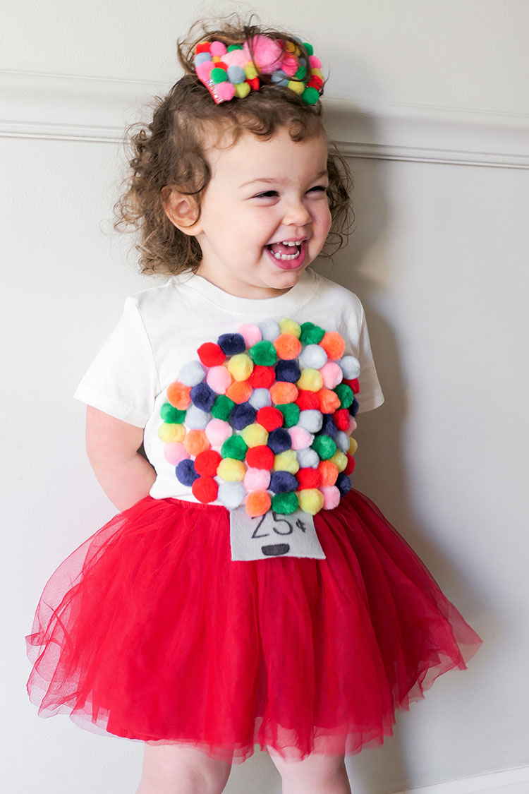 Toddler girl in diy gumball machine costume with red tutu