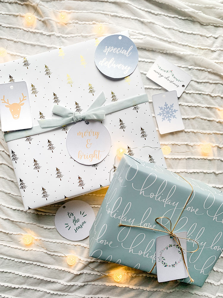 Printable gift tags in pretty blue, white, gold color scheme wrapped on holiday gifts