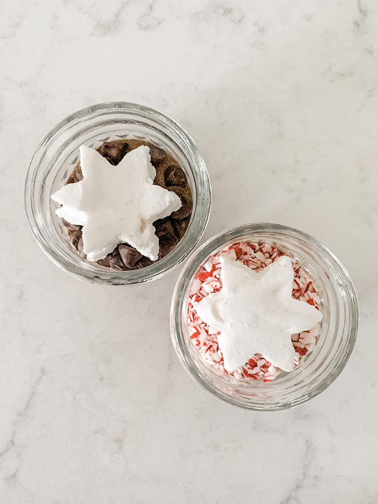 Mini hot cocoa jars filled with cocoa mix and homemade marshmallows