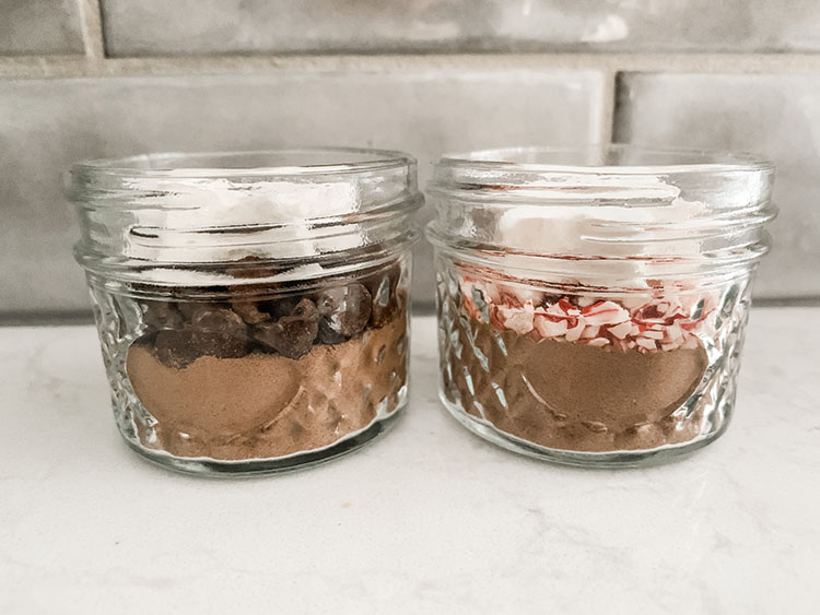 Mini hot cocoa jars filled with cocoa mix and homemade marshmallows