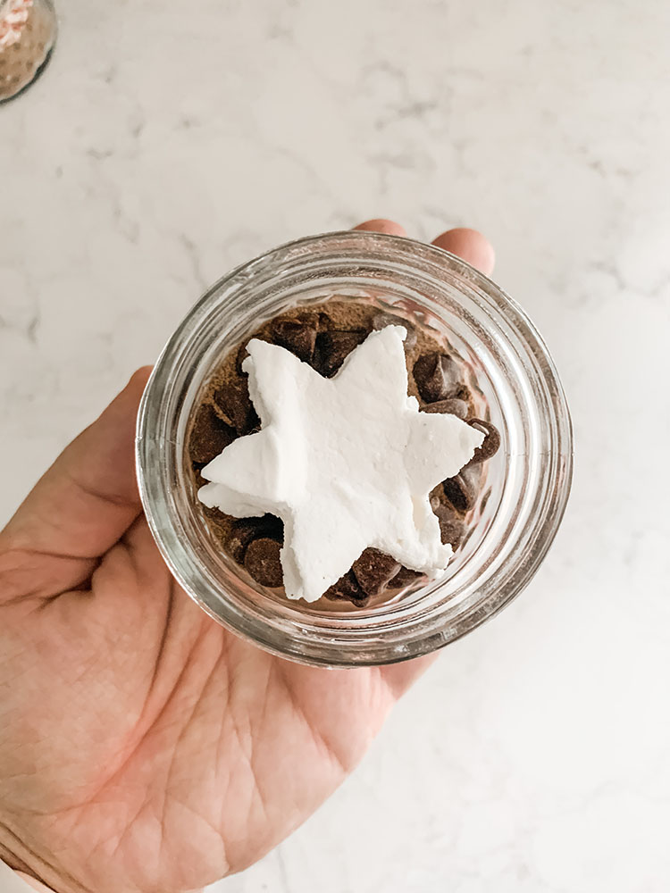 Mini hot cocoa jars filled with cocoa mix and homemade marshmallows