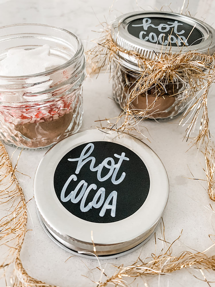 Mini hot cocoa jars filled with cocoa mix and homemade marshmallows