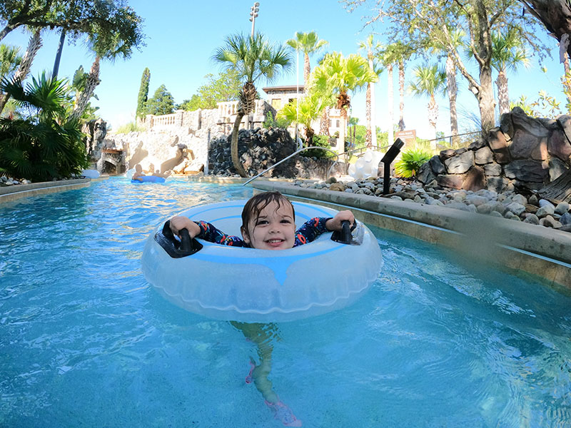 Little girl riding in water tube through the lazy river at Orlando's Four Season Resort.