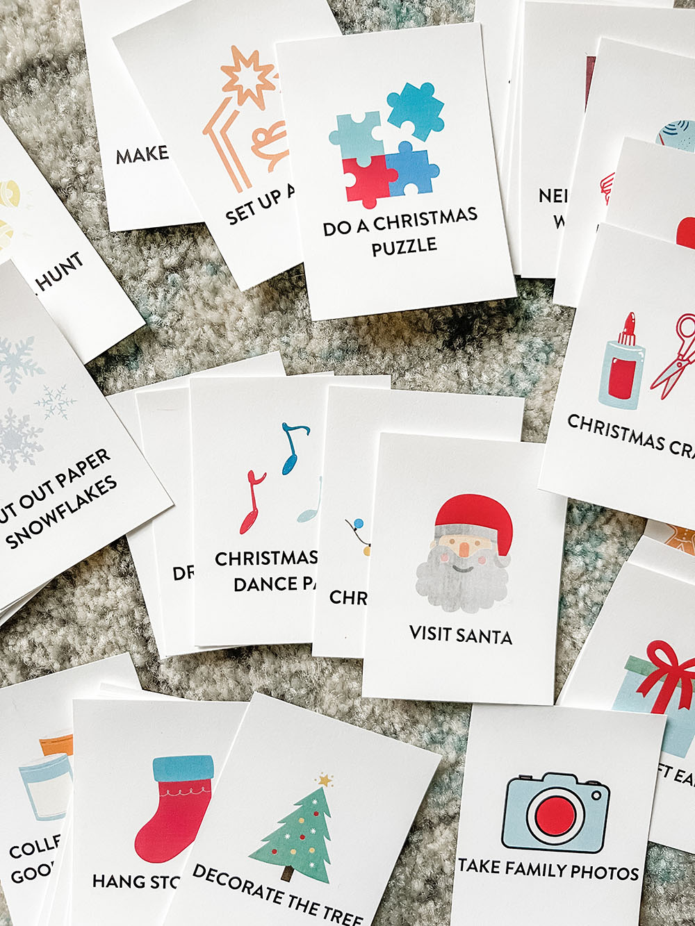 Printable advent calendar cards that are perfect for families such as "do a Christmas puzzle", "visit Santa", "Christmas music dance party", "make a Christmas craft" and more.