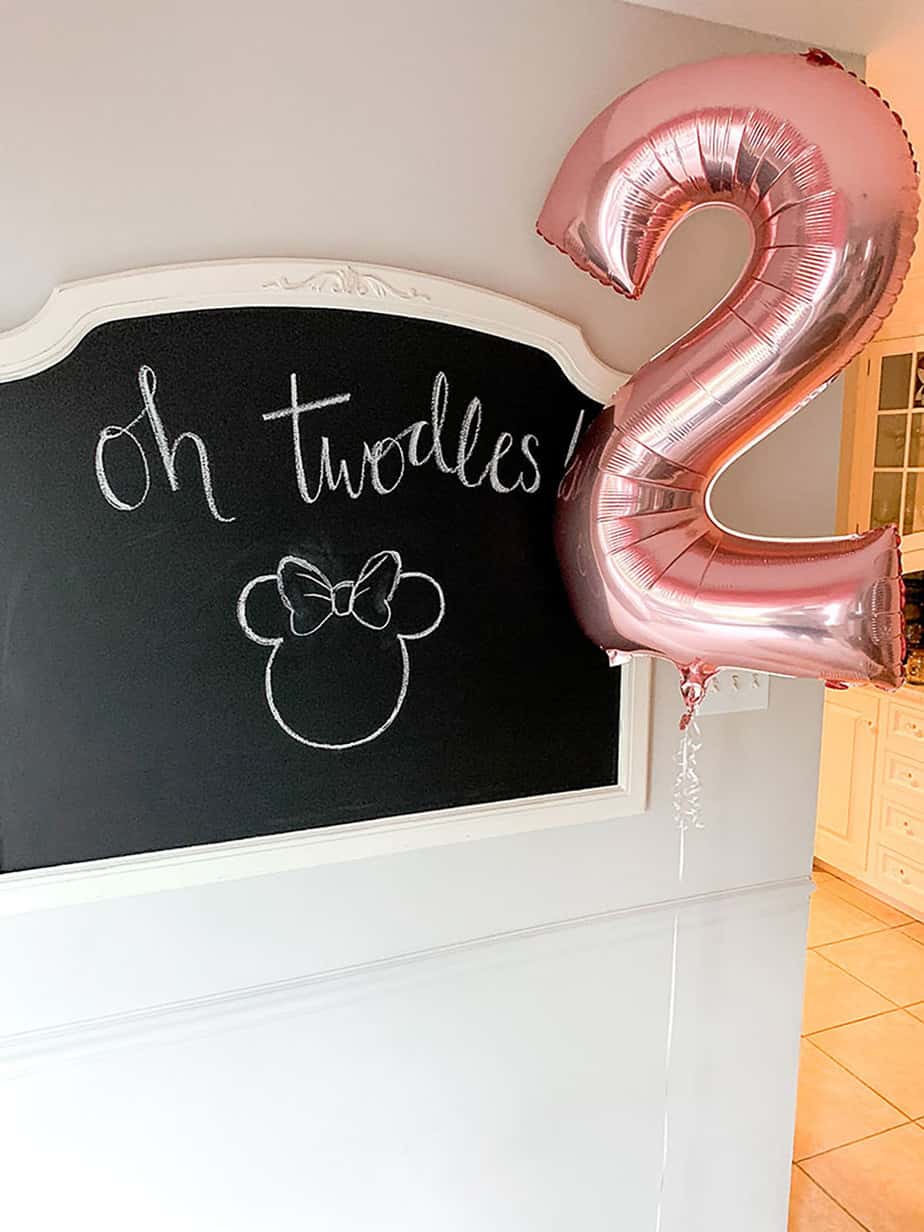 Chalkboard with Oh Twodles written on it and Minnie Mouse drawn next to large #2 pink balloon.
