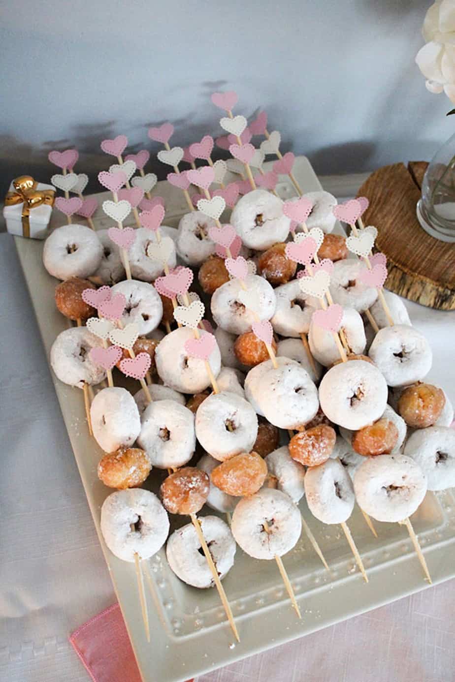 Mini donut and donut hole skewers with DIY pink and white hearts glued to the top.