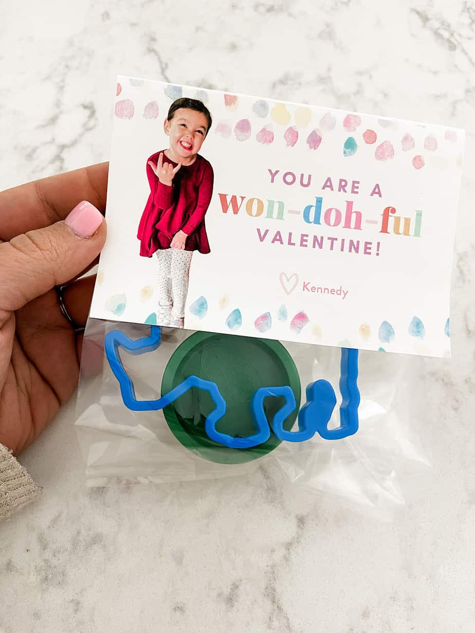 "you are a won-doh-ful valentine" label on clear bag filled with tub of playdoh and animal shaped cookie cutter.