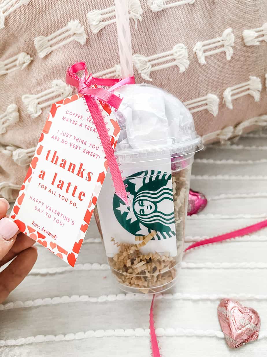 Clear coffee cup filled with chocolates and a gift card with tag tied on saying "thanks a latte"