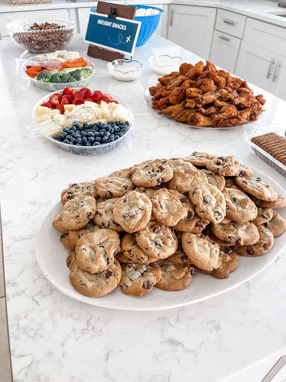 Inflight snack bar set up with pretzels, cookies, wings, and other foods for party