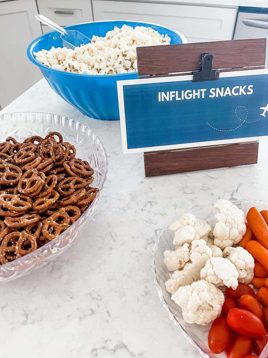 Inflight snack bar set up with pretzels, cookies, wings, and other foods for party
