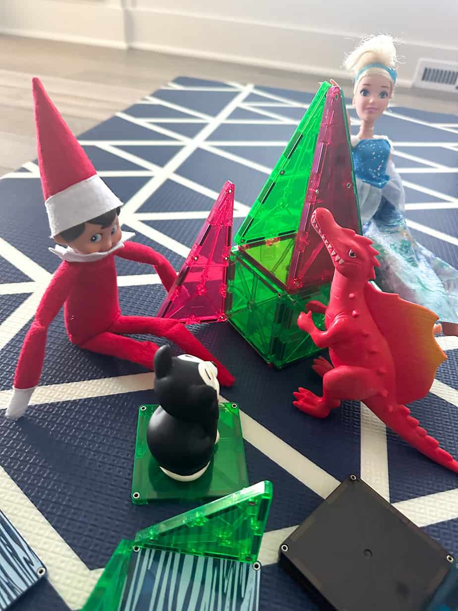 elf on the shelf building blocks with Cinderella, dinosaur, and cat friends