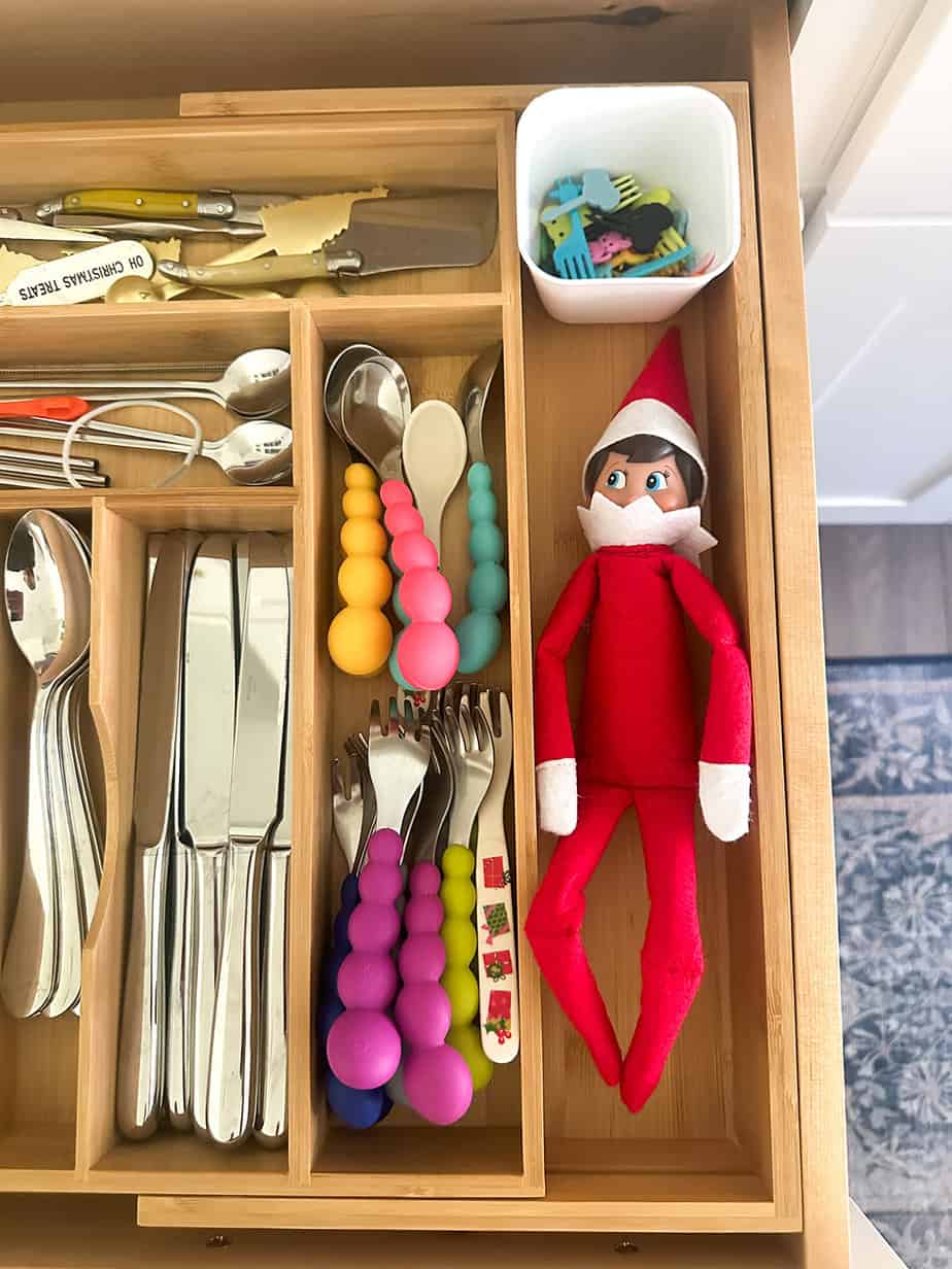 elf on the shelf hiding in the utensil drawer