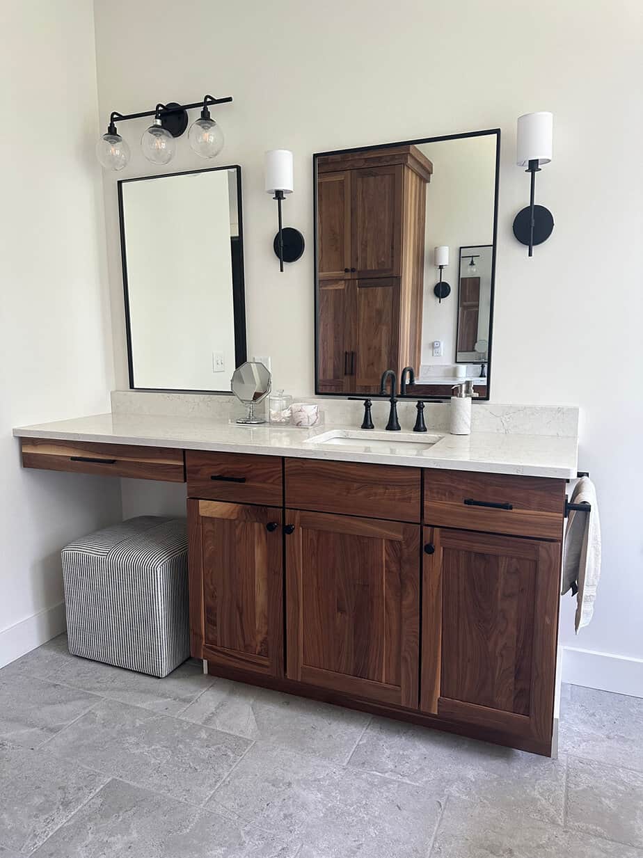 walnut bathroom cabinets and his and her vanities in a neutral master bath