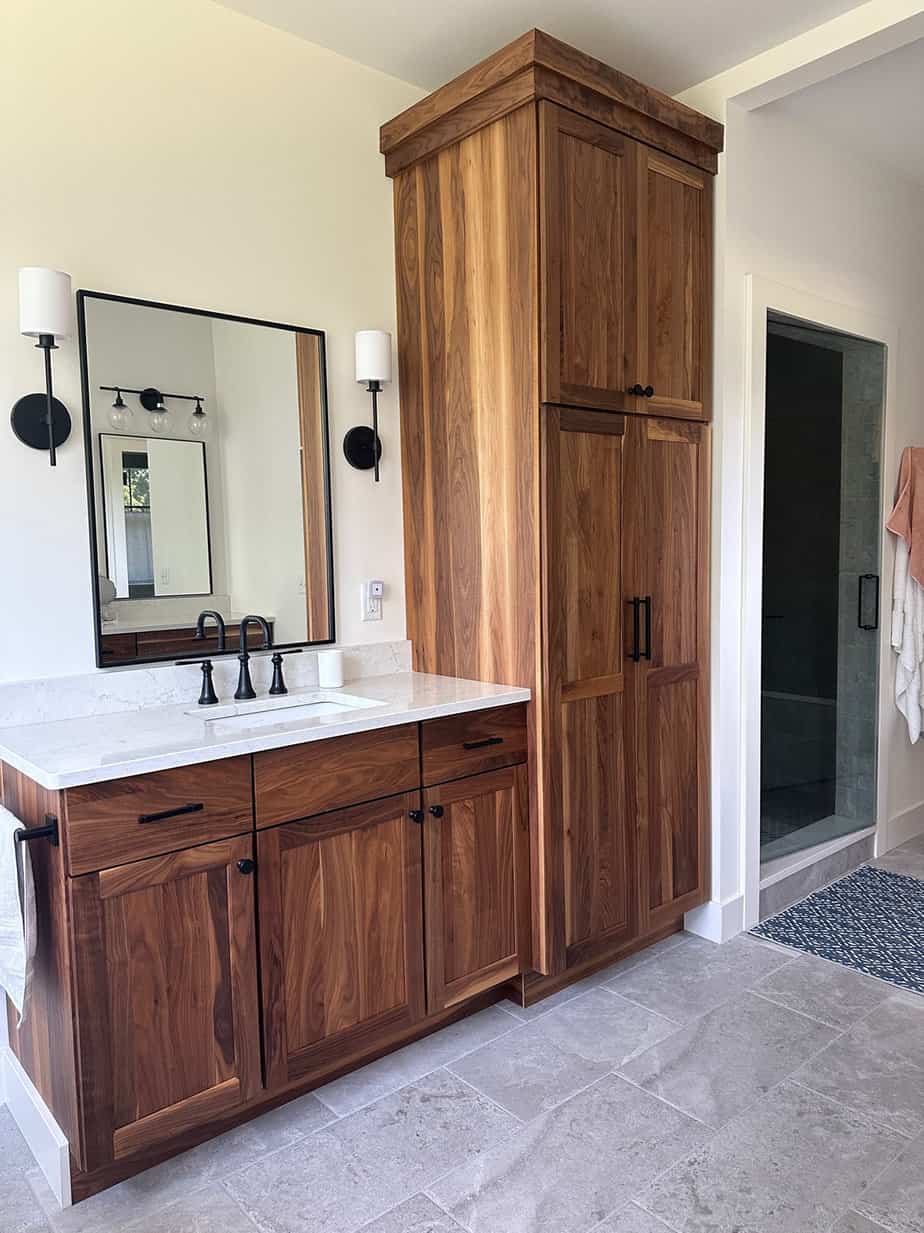 walnut bathroom cabinets and his and her vanities in a neutral master bath